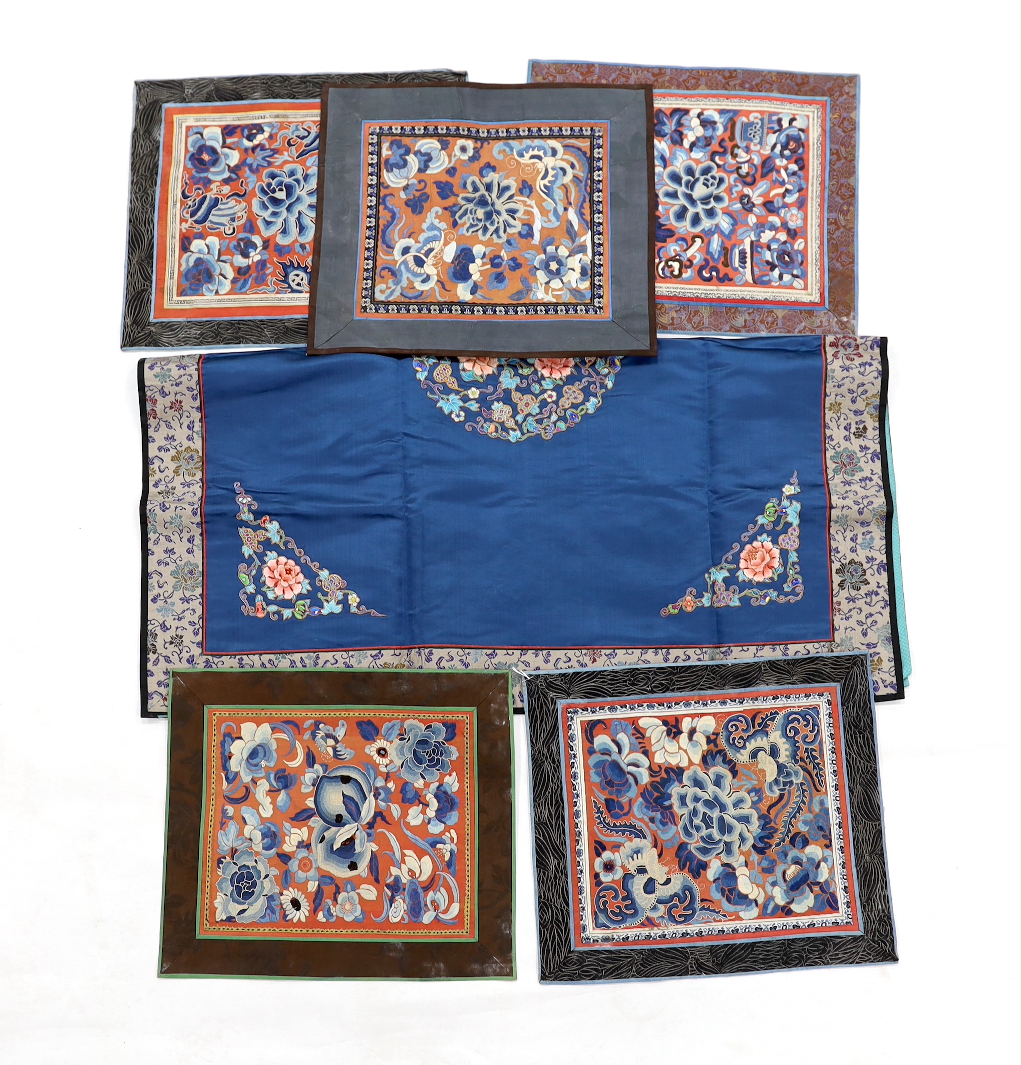 Five Chinese embroidered mats with polychrome silk embroidery using Beijing knot stitch, together with a large square blue silk cover with silk embroidered spot motifs and gold thread work, all items bordered with silk b